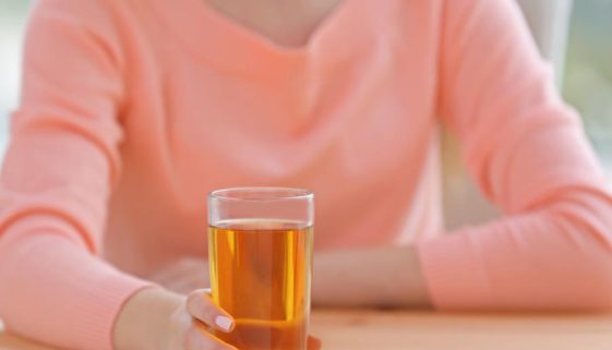 Young beautiful  woman with glass of juice